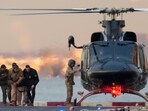 Maduro was handcuffed, and seemed to be limping before getting onto the helicopter. 