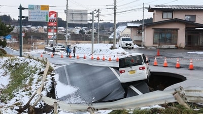 A vehicle rests on the edge of a collapsed road in Tohoku town in Aomori Prefecture on December 9, 2025, following a 7.5 magnitude earthquake off northern Japan. (AFP) A vehicle rests on the edge of a collapsed road in Tohoku town in Aomori Prefecture on December 9, 2025, following a 7.5 magnitude earthquake off northern Japan. (AFP)