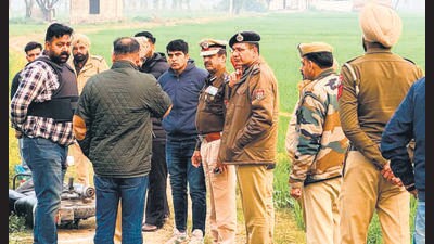 Police officials at the encounter site near Bhikhiwind in Tarn Taran district on Tuesday. (HT Photo) Police officials at the encounter site near Bhikhiwind in Tarn Taran district on Tuesday. (HT Photo)