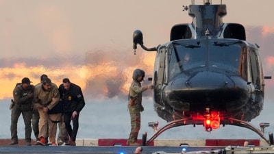Maduro was handcuffed, and seemed to be limping before getting onto the helicopter. (REUTERS)