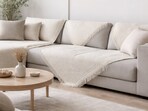 Minimal patterns and refined colours help a sofa cover add instant polish, turning everyday seating into a modern focal point.(AI generated)