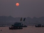 People ride boats during sunset, at the Sangam, in Prayagraj on Wednesday (PTI)