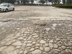 The damaged stretch of Sector 69 main road as seen on Tuesday. (Parveen Kumar/HT) The damaged stretch of Sector 69 main road as seen on Tuesday. (Parveen Kumar/HT)