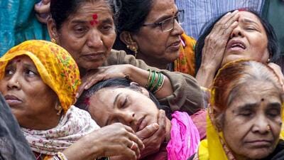 Family members of a victim, who died after consumption of allegedly contaminated water, mourn in the Bhagirathpura area of Indore. (PTI FILE PHOTO)