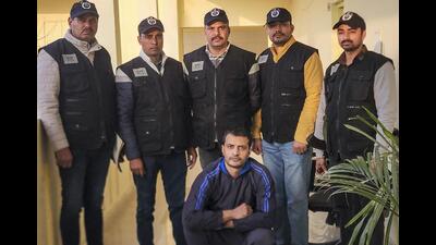 Haryana Special Task Force (STF) personnel produce wanted gangster Aman Bhainswal after his deportation from the United States in Gurugram on Wednesday. (PTI) Haryana Special Task Force (STF) personnel produce wanted gangster Aman Bhainswal after his deportation from the United States in Gurugram on Wednesday. (PTI)