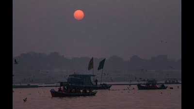 People ride boats during sunset, at the Sangam, in Prayagraj on Wednesday (PTI)
