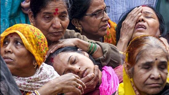Family members of a victim, who died after consumption of allegedly contaminated water, mourn in the Bhagirathpura area of Indore. (PTI FILE PHOTO)