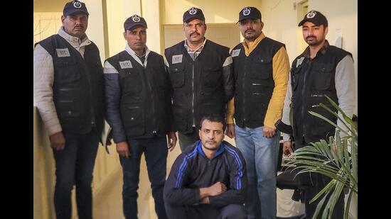 Haryana Special Task Force (STF) personnel produce wanted gangster Aman Bhainswal after his deportation from the United States in Gurugram on Wednesday. (PTI)