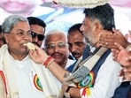 Karnataka deputy chief minister DK Shivakumar offers cake to chief minister Siddaramaiah as he surpasses former CM D Devaraj Urs as the longest-serving CM of the State, in Haveri on Wednesday. (@DKShivakumar)
