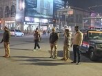 Police personnel patrolling the Hazratganj crossing in Lucknow late on Wednesday evening. (Mushtaq Ali/HT Photo)