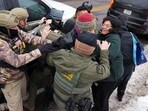 Federal agents scuffle with protesters as immigration enforcement action continues the day after the fatal shooting of Renee Nicole Good by a U.S. Immigration and Customs Enforcement (ICE) agent, in Minneapolis, Minnesota.