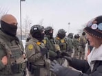 Screengrab of video shows protestor about to hug border patrol agent. 