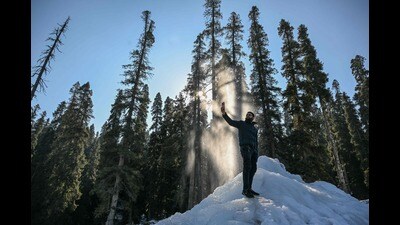 A man takes selfies on icicles, on a cold winter morning in Baramulla on Thursday. (AFP)