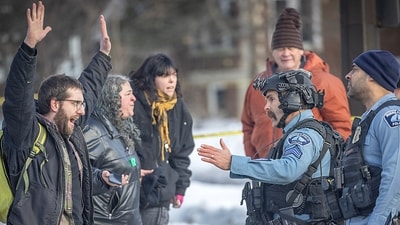 Protesters confront law enforcement officers at the scene of a shooting in Minneapolis, on Wednesday, Jan. 7, 2026. (Elizabeth Flores/Star Tribune via AP) (AP) Protesters confront law enforcement officers at the scene of a shooting in Minneapolis, on Wednesday, Jan. 7, 2026. (Elizabeth Flores/Star Tribune via AP) (AP)
