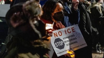 Community members during a vigil following a fatal shooting by an Immigration and Customs Enforcement (ICE) agent in Minneapolis, Minnesota, US, on Wednesday, Jan. 7, 2026. (Photographer: Jaida Grey Eagle/Bloomberg) (Bloomberg) Community members during a vigil following a fatal shooting by an Immigration and Customs Enforcement (ICE) agent in Minneapolis, Minnesota, US, on Wednesday, Jan. 7, 2026. (Photographer: Jaida Grey Eagle/Bloomberg) (Bloomberg)