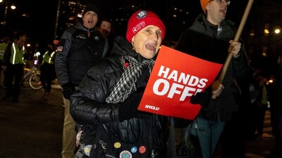 People protest against ICE, holding a 'Hands Off" sign, after a US immigration agent shot and killed a 37-year-old woman in her car. REUTERS/Angelina Katsanis (REUTERS)