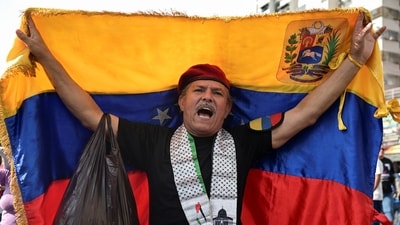 A government supporter holds a Venezuelan flag during a march calling for the release of Venezuela's ousted president Nicolas Maduro, days after he and his wife Cilia Flores were captured following U.S. strikes on Venezuela, in Caracas, Venezuela, January 7, 2026. REUTERS/Gaby Oraa (REUTERS)