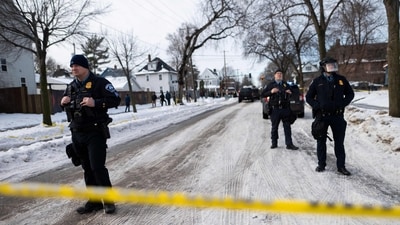 Minneapolis Police officers look on as members of law enforcement hold a perimeter around the scene where Renne Nicole Good was shot. (Getty Images via AFP) Minneapolis Police officers look on as members of law enforcement hold a perimeter around the scene where Renne Nicole Good was shot. (Getty Images via AFP)