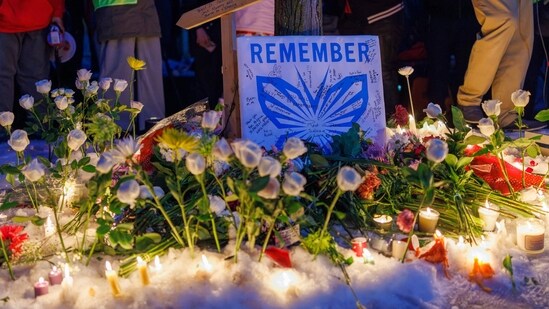 People demonstrate during a vigil at the site where a woman was shot and killed by an immigration officer earlier in the day in Minneapolis, Minnesota, on January 7, 2026. (Photo by Kerem YUCEL / AFP) (AFP)