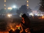 A man warms himself by a fire in front of the Jama Masjid on a cold winter evening in Delhi.