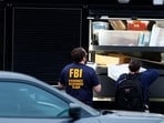 FBI agents work outside Adventist Hospital after U.S. federal agents shot two people in Portland, Oregon.