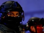 A Riot police officer looks on as demonstrators gather outside the Portland ICE facility to protest after U.S. federal agents shot two people in Portland, Oregon, U.S., January 8, 2026. 