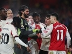 Players from both teams react as Liverpool's Ibrahima Konate clashes with Arsenal's Gabriel Martinelli. 