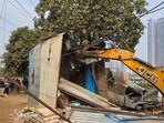 The DTP enforcement team under GMDA Infra-1 division used one JCB machine and were assisted by 50 police personnel for the drive. (HT Photo)