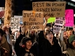 People hold signs and chant during a protest the day after the fatal shooting of Minneapolis resident Renee Nicole Good by a US Immigration and Customs Enforcement (ICE) agent, outside the ICE Field Office in Phoenix, Arizona.