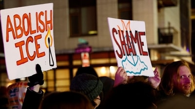 Demonstrators hold posters outside the Portland ICE facility, with one sign reading ‘Abolish ICE’ and another reading ‘Shame’. REUTERS/John Rudoff (REUTERS)