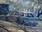 A burnt car stands at a property during a bushfire in Longwood, Victoria, Australia.
