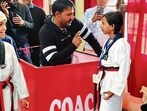 Father of a taekwondo player from Haryana, Harshita Punia, guiding her before her match in Ludhiana. (HT Photo)
