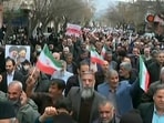 This grab taken from handout video footage released by Iran Press on January 9, 2026, shows pro-government demonstrators chanting slogans as they march along a main street in Khorramabad, western Iran.