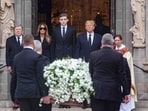 Melania Trump, Barron Trump, and President Donald Trump watch as the casket of Melania's mother Amalija Knavs is brought