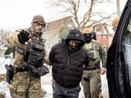 Federal agents detain a person in Minneapolis, Minn., on Sunday, Jan. 11, 2026. 