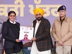 Punjab chief minister Bhagwant Mann handing over appointment letter to a newly recruited Punjab Police constable in Jalandhar on Sunday. (HT)