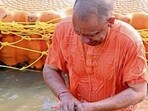 Uttar Pradesh chief minister Yogi Adityanath taking a holy dip in the Sangam waters, in Prayagraj on Saturday (HT Photo)