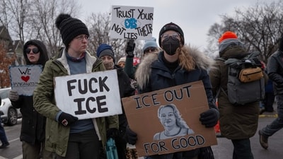 MINNEAPOLIS, MINNESOTA - JANUARY 10: EDITOR'S NOTE: Image contains profanity. Demonstrators march from Powderhorn Park past the site where Renee Good was killed on January 10, 2026 in Minneapolis, Minnesota. Good was fatally shot by an immigration enforcement agent during an incident in south Minneapolis on January 7.   Scott Olson/Getty Images/AFP (Photo by SCOTT OLSON / GETTY IMAGES NORTH AMERICA / Getty Images via AFP) (Getty Images via AFP)