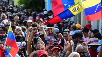 A demonstrator holds a toy of the caped superhero named "Super-Bigote" (Super-Mustache) during a rally in support of ousted Venezuela's President Nicolas Maduro in Valencia, Carabobo state, Venezuela (AFP) A demonstrator holds a toy of the caped superhero named "Super-Bigote" (Super-Mustache) during a rally in support of ousted Venezuela's President Nicolas Maduro in Valencia, Carabobo state, Venezuela (AFP)