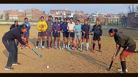 Players practising hockey at the sports nursery set up by the district sports department at Mundiyan Khurd in Ludhiana on Sunday. (HT Photo)