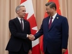 Canadian Prime Minister Mark Carney, left, shakes hands with Chinese President Xi Jinping.