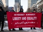 Protesters display placards and banners criticising the Iranian regime during a rally in Berlin, Germany, on January 10, 2026, in support of the Iran protests. 