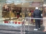 The shattered glass door after three men opened fire at a sweet shop on the Phagwara-Hoshiarpur road on Monday.