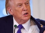 President Donald Trump displays what he called a "Happy Trump" pin.