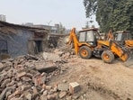 Unused quarters belonging to PWSSB along the Mall Road being demolished in Ludhiana on Monday. (Gurpreet Singh/HT)