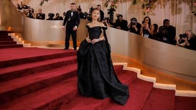 Ariana Grande brought drama to the Globes red carpet in a Vivienne Westwood gown. Her voluminous, off-the-shoulder black ballgown featured a corseted bodice, a plunging V-neck back, and a dramatic bubble train — a subtle silhouette nod to her Wicked character despite the dark colour. (REUTERS)