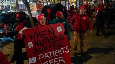 A woman holds huge banner that read ‘When Nurses Suffer Patients Suffer’ outside Mount Sinai West Hospital. (AP Photo/Yuki Iwamura) (AP) A woman holds huge banner that read ‘When Nurses Suffer Patients Suffer’ outside Mount Sinai West Hospital. (AP Photo/Yuki Iwamura) (AP)