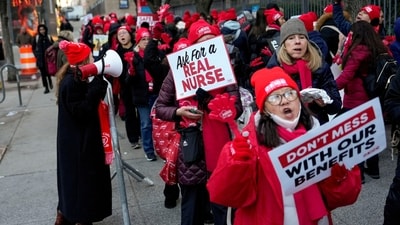 Women held banners during the nurses' strike outside Mount Sinai West Hospital, with messages including ‘Ask for a Real Nurse’ and ‘Don’t Mess with Our Benefits.' (AP Photo/Yuki Iwamura) (AP) Women held banners during the nurses' strike outside Mount Sinai West Hospital, with messages including ‘Ask for a Real Nurse’ and ‘Don’t Mess with Our Benefits.' (AP Photo/Yuki Iwamura) (AP)