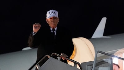 US President Donald Trump gestures as he disembarks Air Force One as he returns from Florida. (REUTERS)