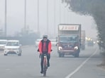 Cyclist ride bicycle at National Highway-48 amid a cold foggy morning near Signature Tower flyover, in Gurugram, India, on Sunday, 11 January 2026. 